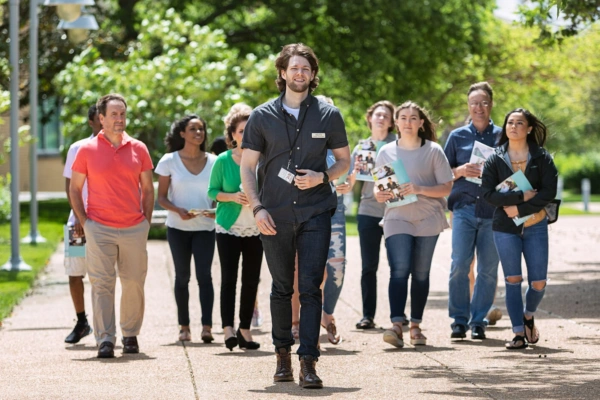 Tour: Guide Leads Group Through College Campus